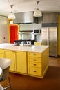 Kitchen yellow wood cabinets stainless stove Royalty Free Stock Photo
