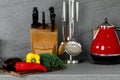 Kitchenware and cutting board with vegetables on countertop Royalty Free Stock Photo