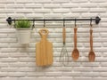 Kitchenware hanging on brick wall.