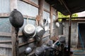 Kitchenware various sized metal pan pot hanging in row on hooks attached on wall galvanized sheet. Royalty Free Stock Photo