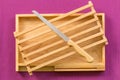 Kitchenware, Vintage cutting bread wood block and tray with stainless steel knife on purple tablecloth