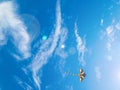 Kite blue sky. Colorful high flying toy. Air kite fly on wind clouds. Rainbow kite in summer background. Concept of Royalty Free Stock Photo