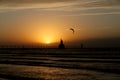 Kite boarder at sunset by a lighthouse Royalty Free Stock Photo