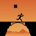 Silhouette of a person flying a kite and running on the bridge