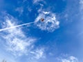 Kite flying in a blue sky with a scary cloud skull Royalty Free Stock Photo