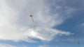 A kite is flying in the wind. on the bright blue sky Royalty Free Stock Photo