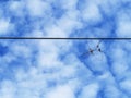 Kite frame on eletric line and blue sky.