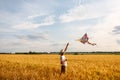 Kite in hand against the blue sky in summer, flying kite launching, fun summer vacation, under the field, freedom Royalty Free Stock Photo