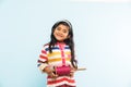 Indian small girl holding spindal or chakri on Makar Sankranti festival, ready to fly Kite Royalty Free Stock Photo