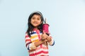 Indian small girl holding spindal or chakri on Makar Sankranti festival, ready to fly Kite Royalty Free Stock Photo