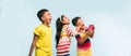 3 indian kids flying kite, one holding spindal or chakri