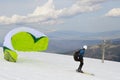 Kite skier flying off the mountain ridge