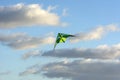 Kite soars in the clouds, blue sky, Sunny day Royalty Free Stock Photo