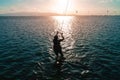 Kite surf on a beautiful sunset on a sandy beach with blue water Royalty Free Stock Photo