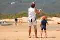 Kite surfer on the beach with a boy Royalty Free Stock Photo