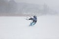 Kite surfer being pulled by his kite across the snow Royalty Free Stock Photo