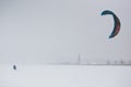 Kite surfer being pulled by his kite across the snow Royalty Free Stock Photo