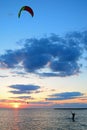 A kite surfer brings in his kite at sunset Royalty Free Stock Photo