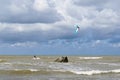 Kite surfer enjoys a brisk wind on the Baltic seashore in Pavilosta