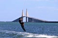 Kite surfer gaining air with a kite above as he attempts to jump the skyway bridge Royalty Free Stock Photo