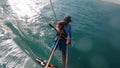 Kite surfer is gliding on water, turning, water splash, view from the slings