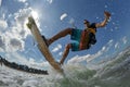 Kite surfer jumps with kiteboard Royalty Free Stock Photo