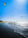 Kite surfer on the ocean beach. Silhouette of kite surfer across the sea shore. Outdoor Active Lifestyle. Royalty Free Stock Photo