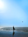 Kite surfer on the ocean beach. Silhouette of kite surfer across the sea shore Royalty Free Stock Photo