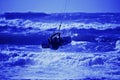 Kite surfer silhouette on blue sky background