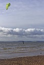 A Kite Surfer in a Wetsuit using the Windy Conditions in the Tay Estuary to do a Jump Royalty Free Stock Photo