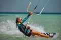 Kite surfer woman rides with kiteboard