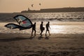 Kite surfers returning from the sea as the sun sets Royalty Free Stock Photo