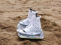 Kite surfing board and boots on sandy beach Royalty Free Stock Photo