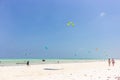 Kite surfing on tropical beach, low tide. Kite surfers on the sea. Scenic Indian Ocean with kite boards, Zanzibar, Paje beach. Royalty Free Stock Photo