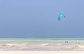 Kite surfing on tropical beach, low tide. Kite surfers on the sea. Scenic Indian Ocean with kite boards, Zanzibar, Paje beach.