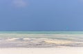 Kite surfing on tropical beach, low tide. Kite surfers on the sea. Scenic Indian Ocean with kite boards, Zanzibar, Paje beach.