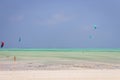 Kite surfing on tropical beach, low tide. Kite surfers on the sea. Scenic Indian Ocean with kite boards, Zanzibar, Paje beach.