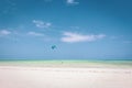 Kite surfing on tropical beach, low tide. Kite surfers on the sea. Scenic Indian Ocean with kite boards, Zanzibar, Paje beach.