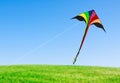 Kite with tail in clear blue sky Royalty Free Stock Photo