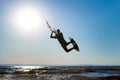 Kiteboarder surfing waves with kiteboard on a sunny summer day Royalty Free Stock Photo