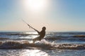 Kiteboarder surfing waves with kiteboard on a sunny summer day Royalty Free Stock Photo