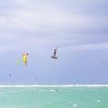 Kiteboarding. Fun in the ocean. Extreme Sport Kitesurfing. Kitesurfer jumping high in the air performing triks during