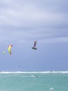 Kiteboarding. Fun in the ocean. Extreme Sport Kitesurfing. Kitesurfer jumping high in the air performing triks during Royalty Free Stock Photo