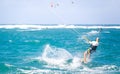 Kiteboarding. Fun in the ocean. Extreme Sport Kitesurfing. Kitesurfer jumping high in the air performing triks during Royalty Free Stock Photo