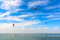 Kiteboarding. A kite surfers rides the waves. Recreational activities, water sports, hobbies and fun in summer. Artistic picture.