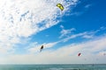 Kiteboarding. A kite surfers rides the waves. Recreational activities, water sports, hobbies and fun in summer. Artistic picture.