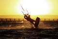 Kiteboarding sportsman silhouette, sunset in the sea