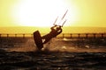 Kiteboarding sportsman silhouette, sunset in the sea
