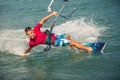 Kiter makes the difficult trick on a beautiful background. Kitesurfing Kiteboarding action photos man among waves