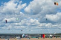 Kiters on the bay on a sunny windy day. People at the beach. Summer sport. Summer lifestyle.